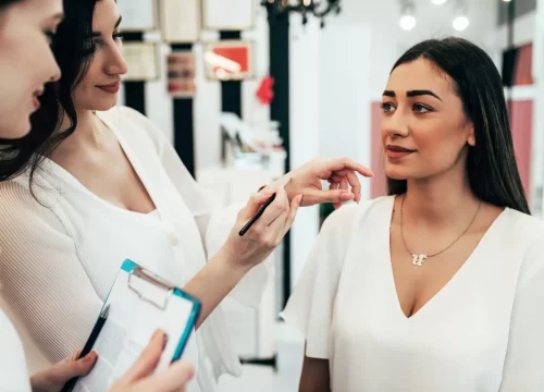 Professional makeup artist teaching student in makeup school. cosmetology student